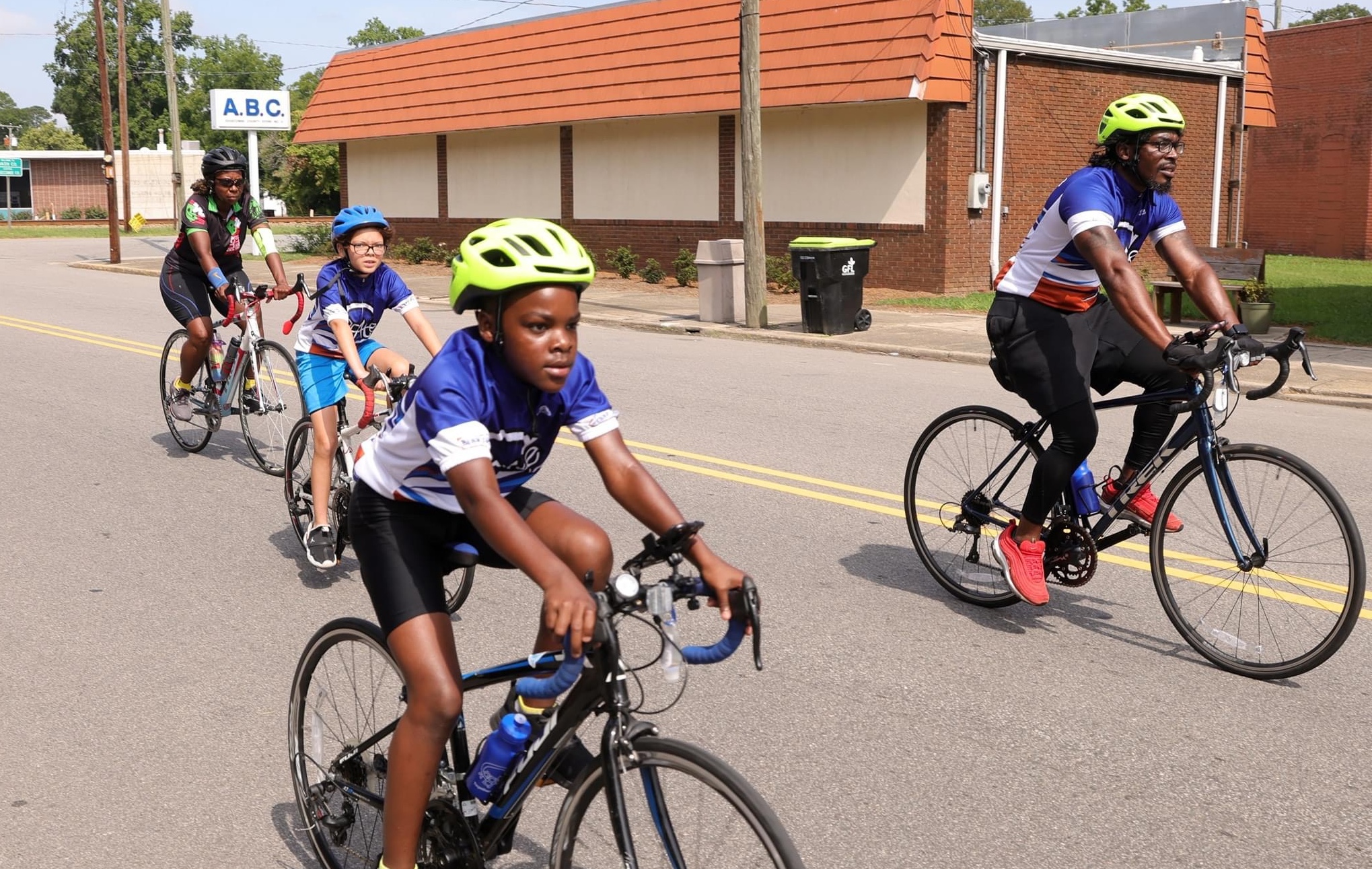 A group of cyclists rides by, eyes on the road